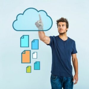 Photo of a man touching a digital cloud  with digital files raining from it.